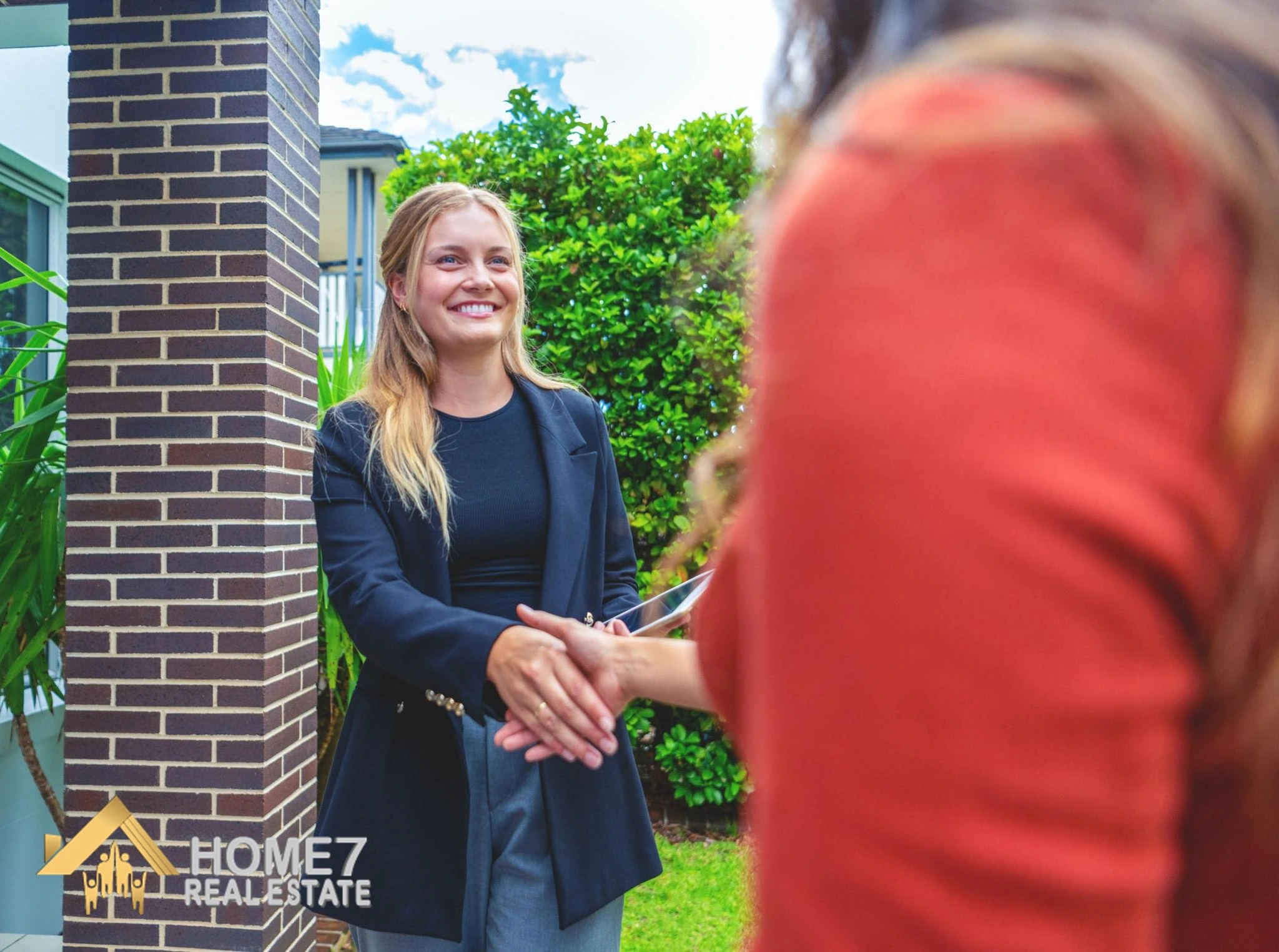 Local real estate agent showing a residential property to prospective investors in Sydney